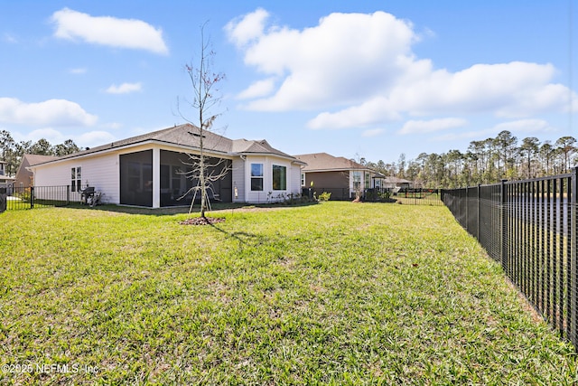 view of yard with a sunroom and a fenced backyard