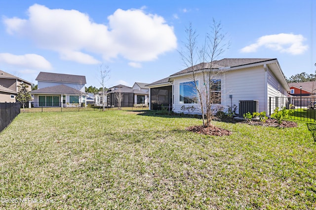 view of yard featuring a residential view, a fenced backyard, a sunroom, and central air condition unit