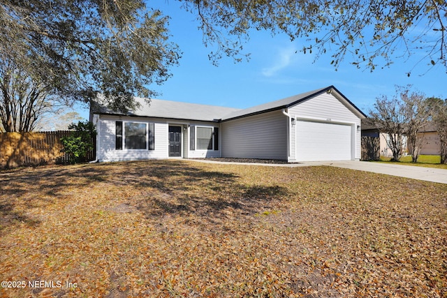 ranch-style home featuring a garage, fence, driveway, and a front lawn