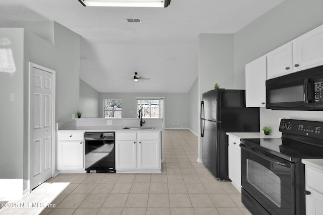 kitchen featuring black appliances, white cabinetry, light countertops, and a sink