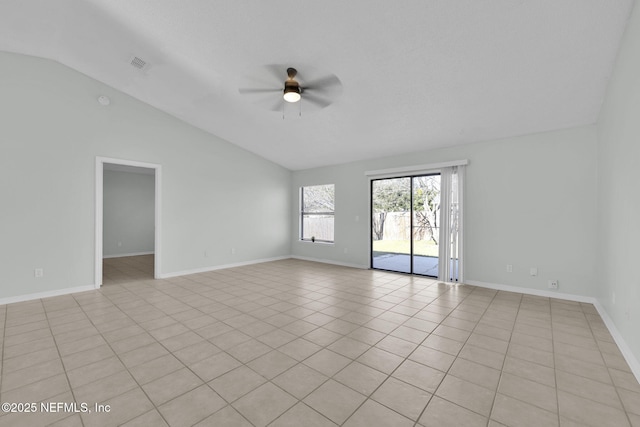 empty room featuring visible vents, a ceiling fan, light tile patterned flooring, vaulted ceiling, and baseboards