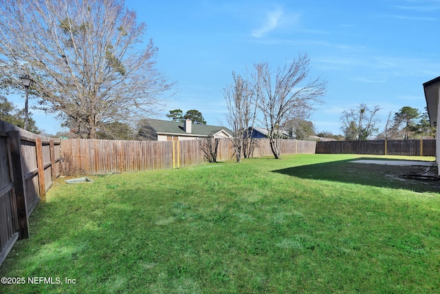 view of yard with a fenced backyard