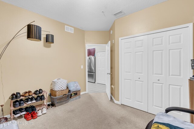 4920 Key Lime Dr Unit 305, Jacksonville, FL 32256 - carpeted bedroom featuring high quality fridge, a closet, and a textured ceiling