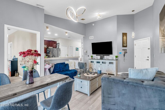 4920 Key Lime Dr Unit 305, Jacksonville, FL 32256 - living area with light wood finished floors and a chandelier