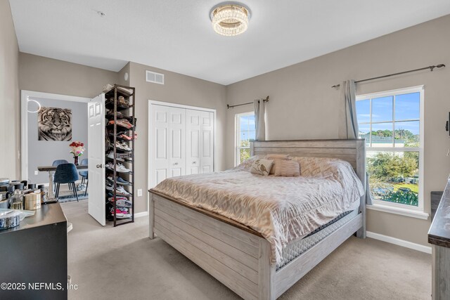 4920 Key Lime Dr Unit 305, Jacksonville, FL 32256 - bedroom featuring light colored carpet, multiple windows, and a closet
