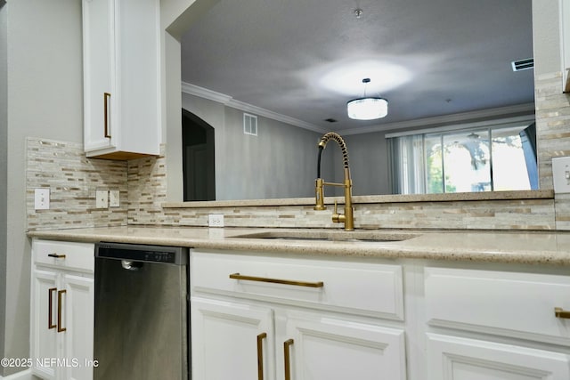 kitchen with dishwasher, ornamental molding, light countertops, white cabinetry, and a sink