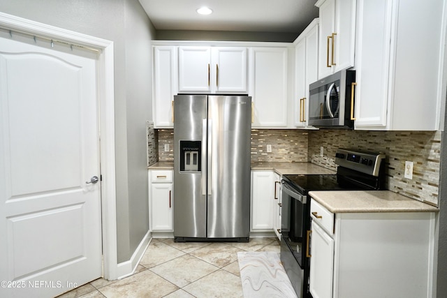 kitchen featuring stainless steel appliances, tasteful backsplash, light countertops, and white cabinets