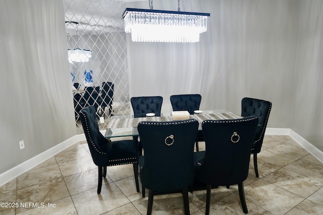 dining space featuring tile walls and baseboards