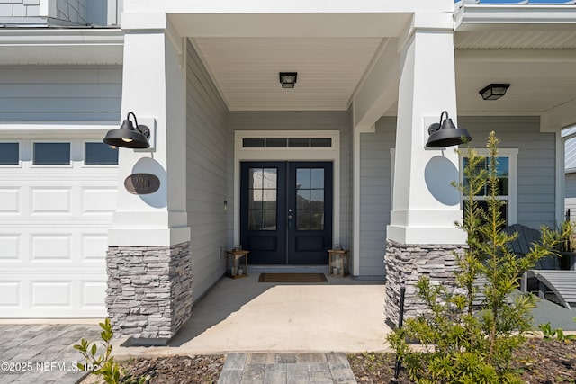 230 Marquesa Cir, Saint Johns, FL 32259 - entrance to property featuring a garage, stone siding, and french doors