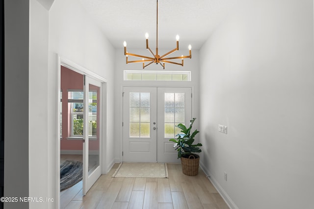 230 Marquesa Cir, Saint Johns, FL 32259 - foyer entrance featuring light wood-type flooring, baseboards, a textured ceiling, and french doors