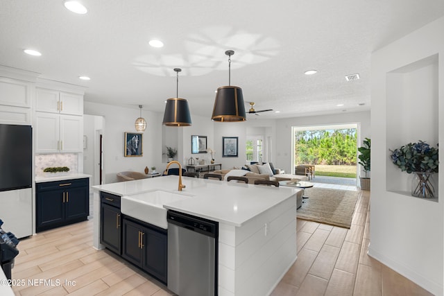 230 Marquesa Cir, Saint Johns, FL 32259 - kitchen with a sink, open floor plan, light countertops, appliances with stainless steel finishes, and wood tiled floor