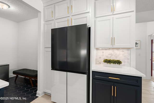 230 Marquesa Cir, Saint Johns, FL 32259 - kitchen featuring white cabinetry, light countertops, and freestanding refrigerator