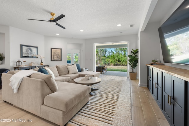 230 Marquesa Cir, Saint Johns, FL 32259 - living room featuring wood tiled floor, visible vents, a textured ceiling, and recessed lighting