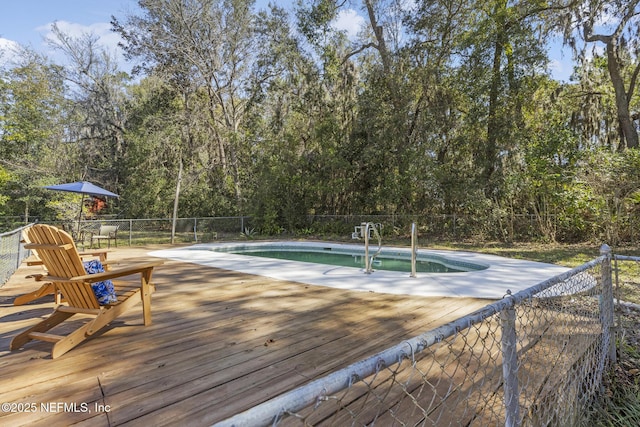 view of swimming pool featuring fence, a fenced in pool, and a wooden deck