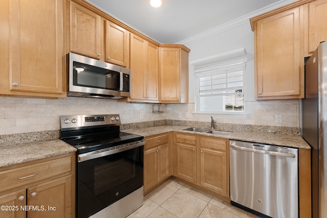 kitchen with light stone counters, stainless steel appliances, a sink, backsplash, and crown molding