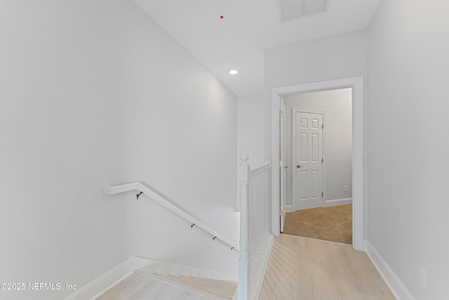 staircase with recessed lighting, visible vents, baseboards, and wood finished floors