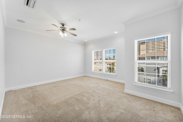 empty room featuring baseboards, visible vents, light colored carpet, and ornamental molding