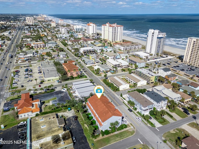 aerial view with a water view, a view of city, and a beach view