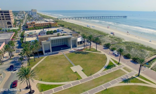 drone / aerial view with a water view and a beach view