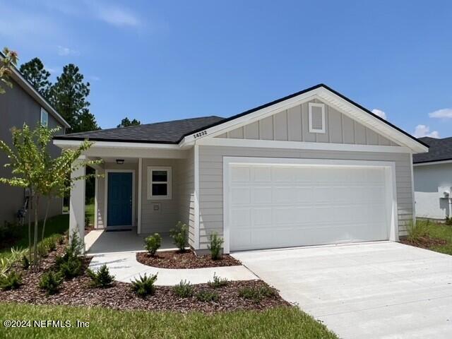 view of front of property featuring board and batten siding, concrete driveway, and an attached garage