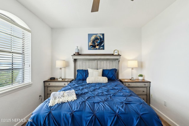 bedroom with ceiling fan and baseboards