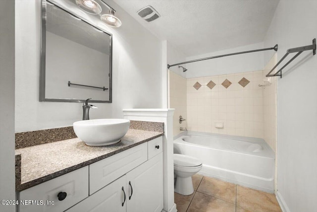 bathroom featuring tile patterned flooring, toilet, vanity, visible vents, and shower / bathing tub combination