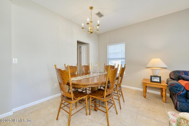 dining room featuring light tile patterned floors, baseboards, visible vents, and a chandelier