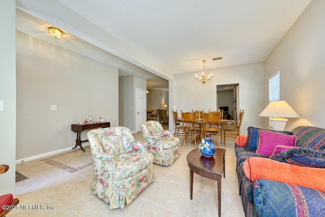 living room with light tile patterned floors, baseboards, visible vents, and a chandelier