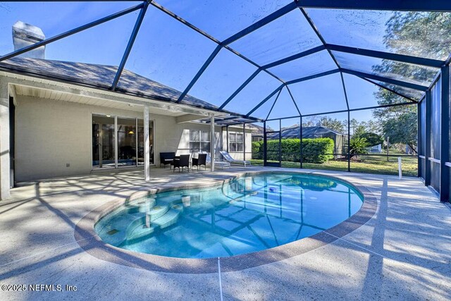 outdoor pool featuring a lanai and a patio