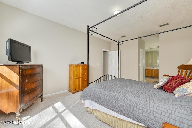 carpeted bedroom with baseboards, visible vents, and a textured ceiling