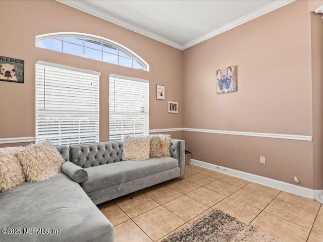 living room with light tile patterned floors, baseboards, and crown molding