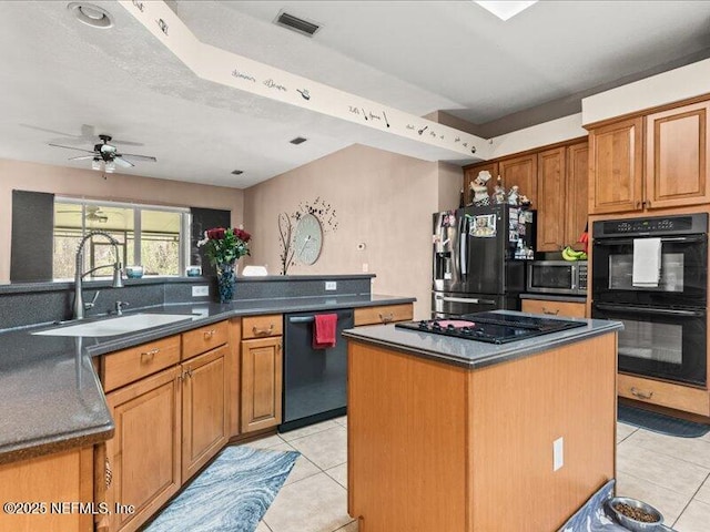 kitchen featuring a sink, a center island, black appliances, brown cabinetry, and dark countertops