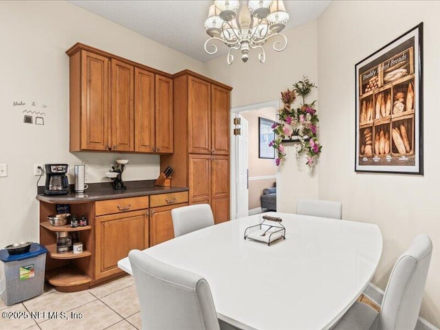 dining space featuring light tile patterned floors and a chandelier