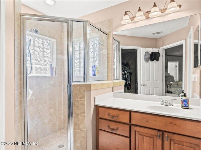 bathroom with visible vents, ensuite bath, vanity, and a shower stall