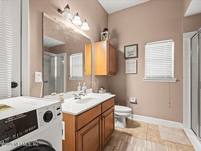 full bath with washer / dryer, a stall shower, tile patterned flooring, and vanity