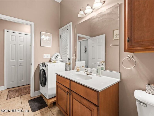 bathroom featuring a closet, toilet, vanity, baseboards, and tile patterned floors