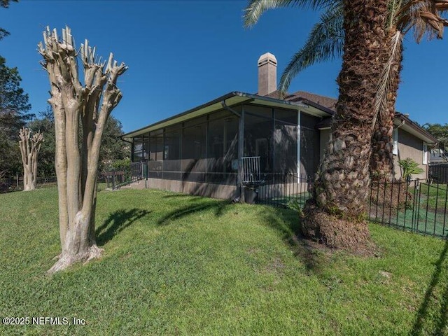 view of yard with fence and a sunroom