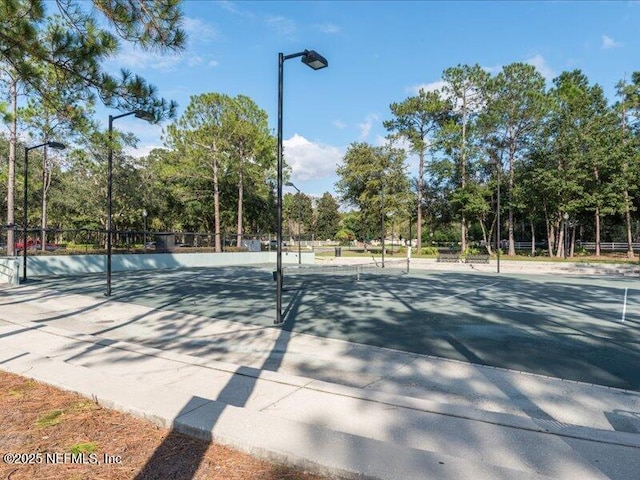 view of tennis court with fence