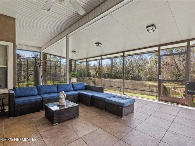 sunroom featuring ceiling fan