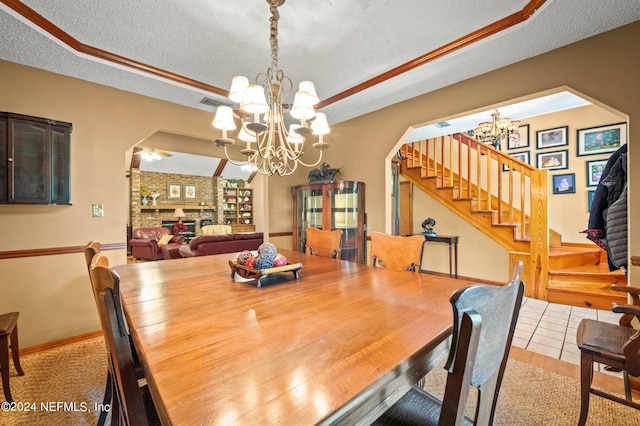 dining space with arched walkways, a notable chandelier, light tile patterned flooring, a textured ceiling, and stairs