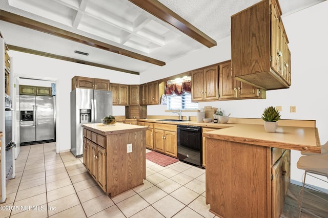 kitchen featuring appliances with stainless steel finishes, light countertops, beamed ceiling, and light tile patterned flooring