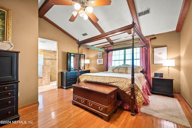 bedroom with lofted ceiling with beams, light wood-style flooring, visible vents, and a textured ceiling