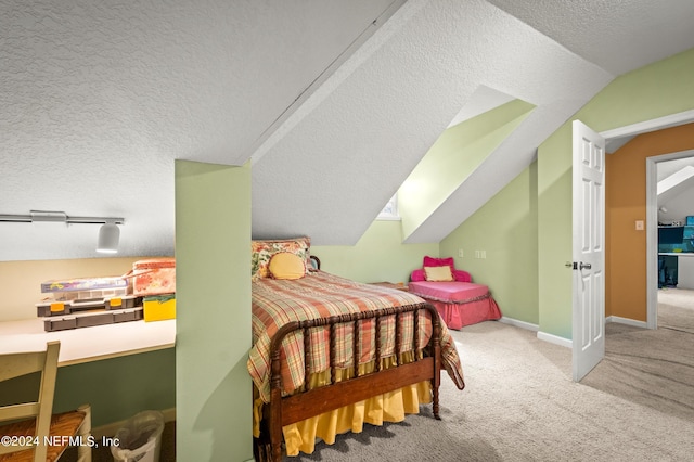 carpeted bedroom with a textured ceiling, vaulted ceiling, and baseboards