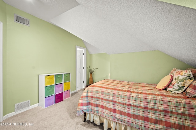 bedroom featuring vaulted ceiling, a textured ceiling, visible vents, and baseboards