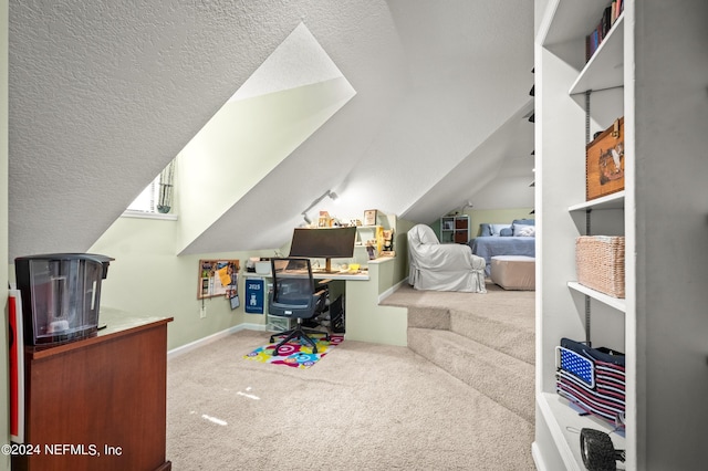 carpeted office with vaulted ceiling, a textured ceiling, and baseboards