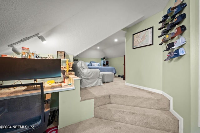 bedroom with lofted ceiling, baseboards, a textured ceiling, and carpet