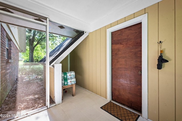 entryway with wooden walls and light floors