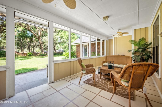 sunroom / solarium featuring ceiling fan