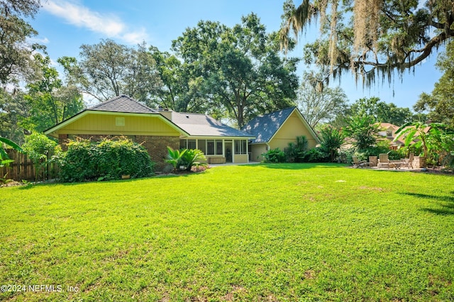 view of yard featuring a sunroom and fence