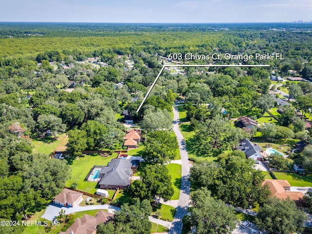 drone / aerial view with a residential view and a wooded view